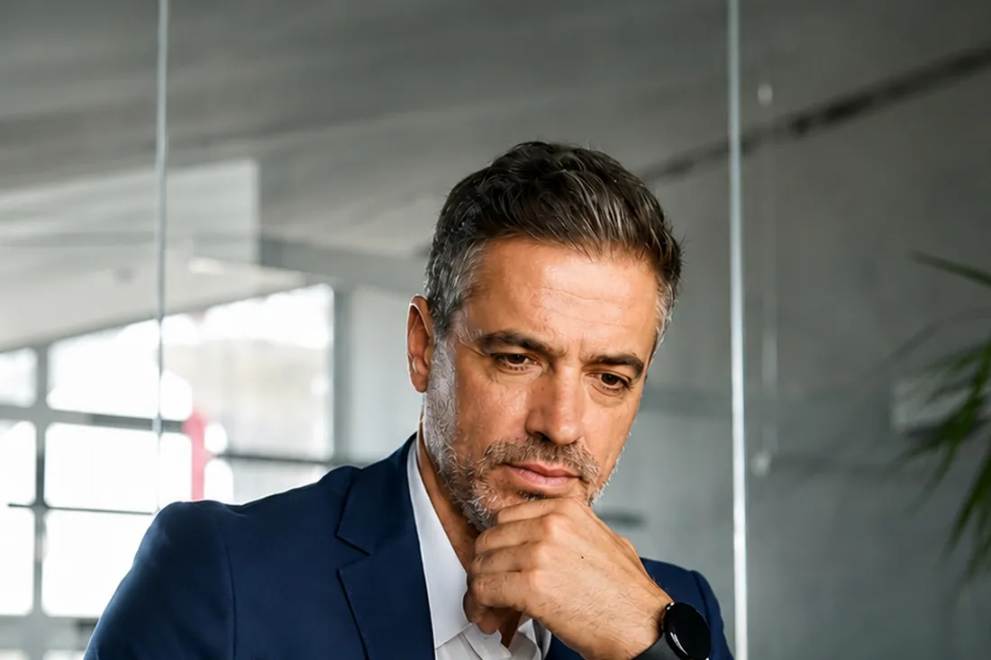 Executivo em escritório avaliando uma decisão.